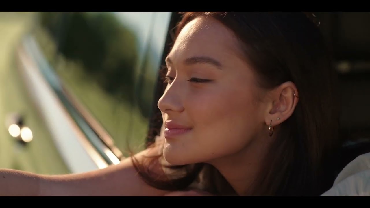 woman leaning out of window (still from Summer I turned pretty)